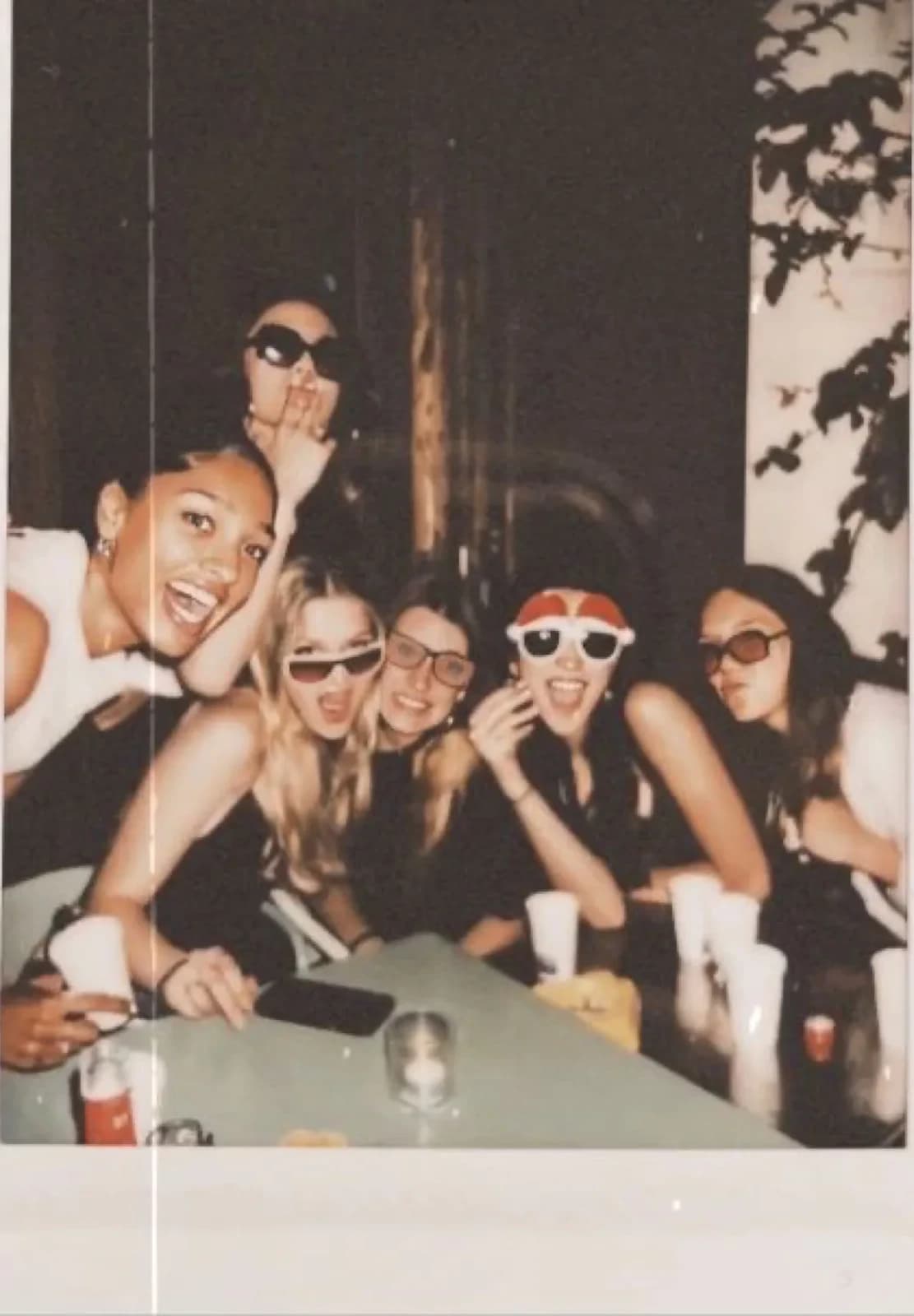 A group of friends squeezed into frame at the end of the night, shot on film