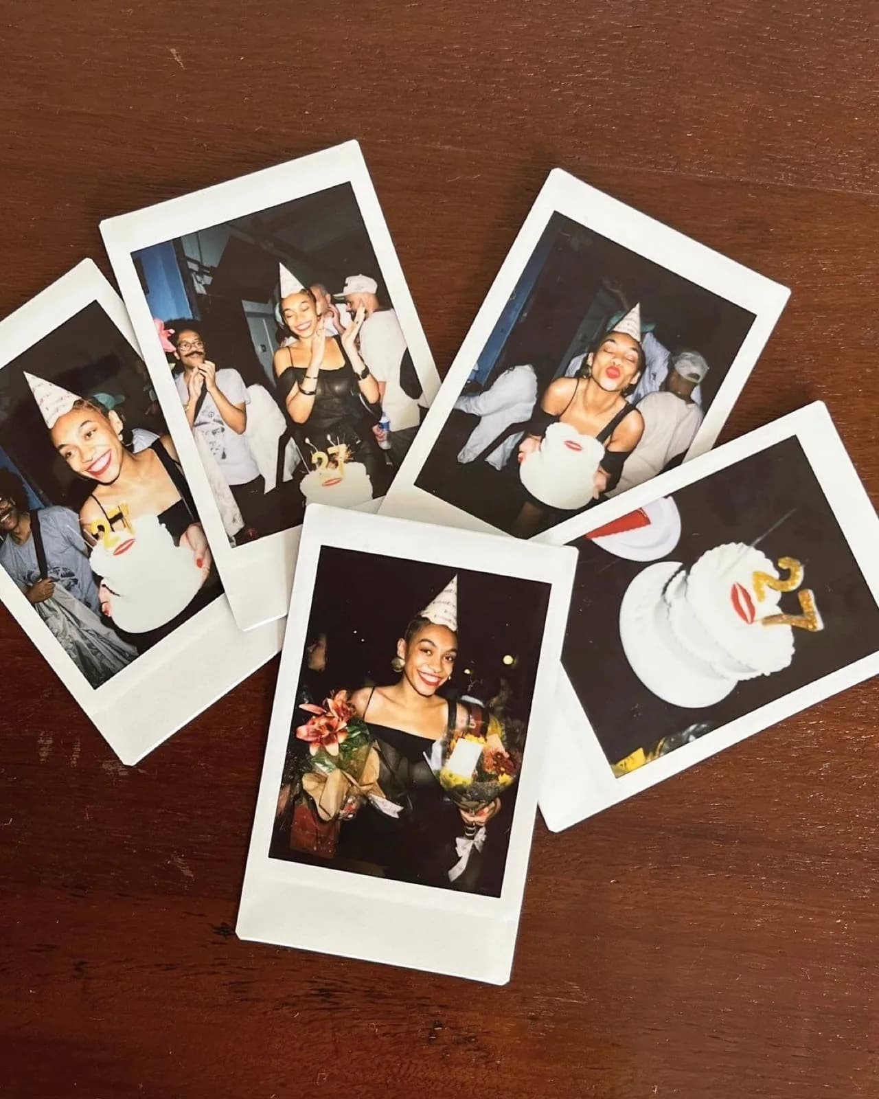 Five birthday polaroids scattered across a wooden table